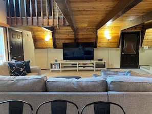 Spacious open living room with seating and tv.