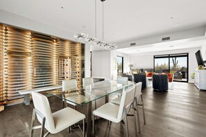 Dining room featuring a floor-to-ceiling glass wine cellar with custom cork flooring