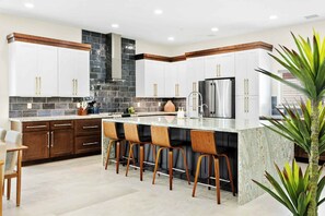 Gourmet kitchen with large island and stainless steel appliances