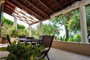 Patio with dining area surrounded by the greenery