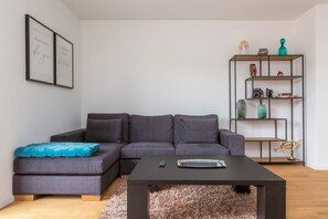 Spacious and bright living room with a comfortable European sofa set and a ceiling fan (which is a rare gem in summer). 
