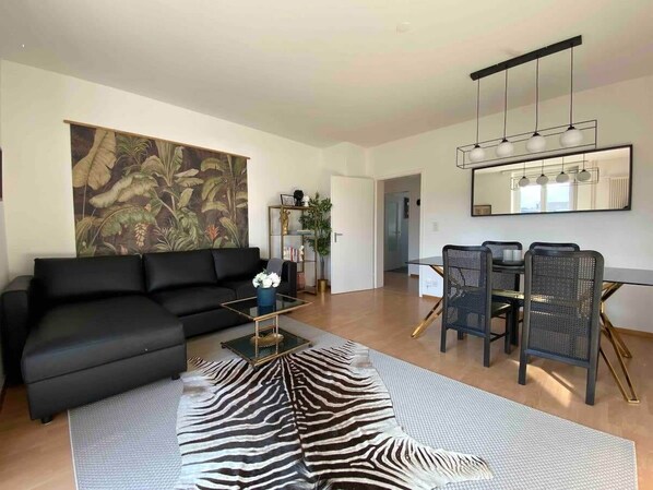 Spacious & bright living room with balcony. 

We would like to inform our upcoming guests that the zebra rug in the living room has been removed as one of our guests have stained it and needs to the professionally cleaned - Sep 2023.