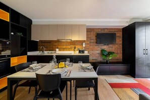 Chic and modern kitchen with a stylish dining area, perfect for cozy meals and entertaining guests.