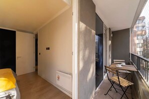 Enjoy your morning coffee on this cozy private balcony with a charming view.