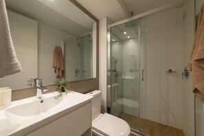 Experience modern comfort in this sleek bathroom with a spacious shower and stylish accents.