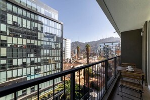 Enjoy your morning coffee with stunning city and hill views from this modern balcony oasis.