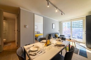 Bright and modern dining area with balcony access, perfect for enjoying meals with a view.