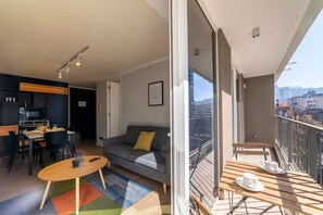 Bright and modern living space with a cozy balcony, perfect for enjoying morning coffee with a view.