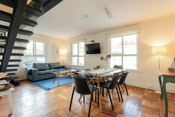 Bright and airy living space with modern decor and ample natural light, perfect for relaxing or entertaining.
