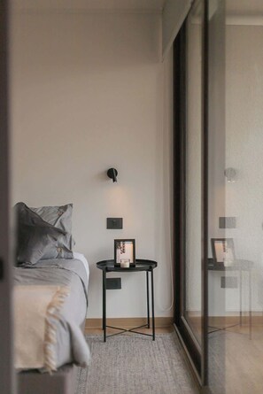 Relax in this cozy bedroom with modern decor and ample natural light, perfect for unwinding after a day exploring Chile.