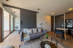 Stylish living area with modern decor and seamless access to a cozy bedroom, perfect for relaxation.