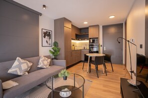 Cozy and modern living space with a sleek kitchen and inviting decor, perfect for a relaxing stay.