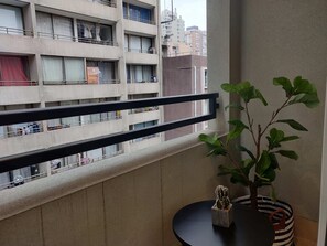 Cozy balcony retreat with city views, perfect for a morning coffee or evening relaxation.