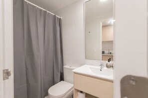 Sleek and modern bathroom with a spacious vanity and contemporary design for a refreshing stay.