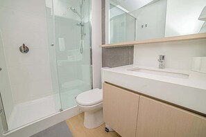 Experience modern comfort in this sleek bathroom with a glass shower and contemporary fixtures.