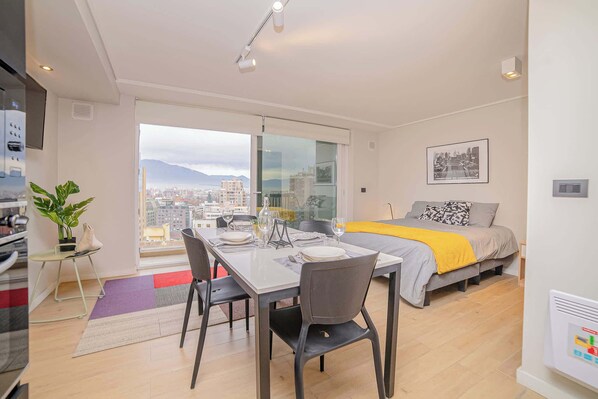 Experience urban living with stunning city views in this modern studio apartment, perfect for a cozy getaway.