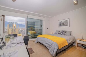 Experience urban living with breathtaking city views in this cozy studio apartment, perfect for a romantic getaway.