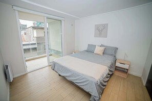 Relax in this cozy bedroom with a private balcony, perfect for enjoying the city views and natural light.