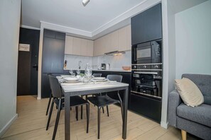 Experience modern comfort in this stylish kitchen and dining area, perfect for cozy meals and relaxation.