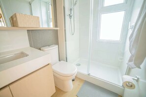 Bright and modern bathroom with sleek fixtures and ample natural light, perfect for a refreshing start to your day.
