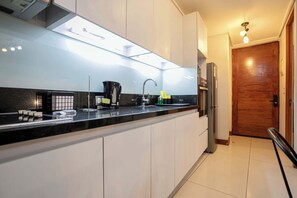 Sleek and modern kitchen with stylish finishes, perfect for cooking a cozy meal in your Chilean studio retreat.