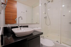 Experience modern comfort in this sleek bathroom with a stylish sink and spacious shower.