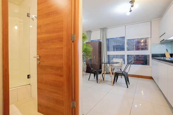 Bright studio with modern dining area and large windows, perfect for a cozy stay in the heart of Chile.