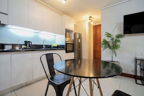 Sleek and modern kitchen with dining area, perfect for cozy meals in a stylish setting.