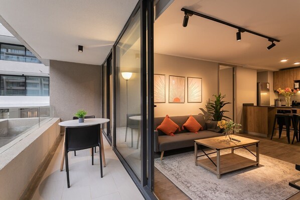 Relax in style with a cozy living room and private balcony, perfect for unwinding after a day of exploring.