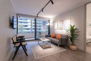 Relax in this stylish living room with a balcony view, perfect for unwinding after a day of exploring.