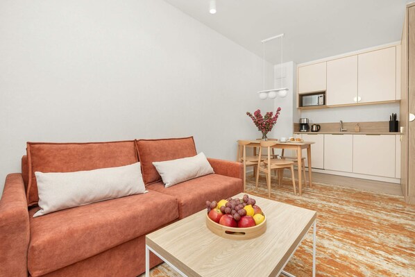 Living room with comfortable orange sofa.