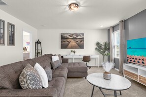 Upstairs TV Lounge and Office Space with Dedicated Laptop-Friendly Workstation