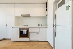 The streamlined kitchen offers all you need to cook meals at home, including a stove, oven, fridge, freezer and microwave.