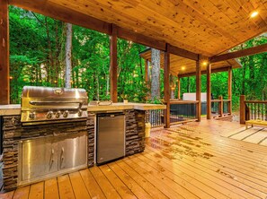 OUTDOOR KITCHEN featuring a grill and mini fridge