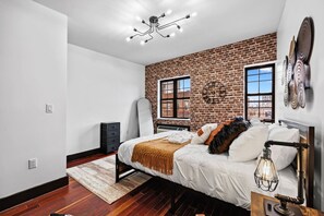Natural light streams through large windows, filling the room with a soft glow that welcomes you every morning.