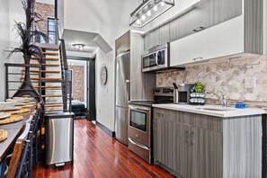 Stainless steel appliances await—from the spacious fridge to the sleek oven—making meal prep feel like a delightful, elevated experience.