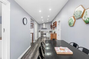 Share home-cooked meals at the eight-seater dining table next to the kitchen.