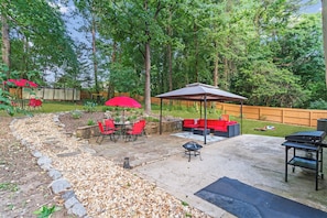 Backyard with patio lounge, outside dining area, firepit, and bbq