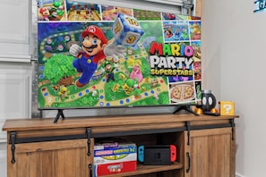 TV rack with lots of games in the game room