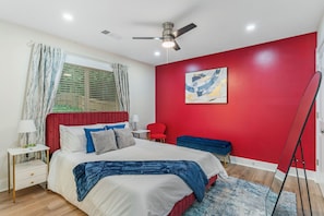 Bedroom with queen bed, ceiling fan, and plush beddings