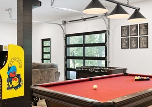 Enjoy your game room with pool table, foosball, pacman arcade, shuffleboard, and projector