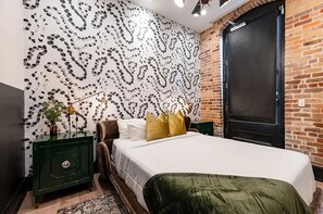 The second bedroom offers a cozy queen bed, dresser, smart TV, and soft linens. Great for families or friends traveling together, this room combines comfort and privacy in the heart of Downtown New Orleans.