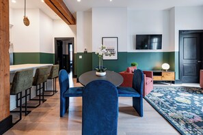 Enjoy meals together at your in-suite dining table with seating for your group. Whether it's takeout, delivery, or a home-cooked meal, this cozy dining area makes every stay at 888 Baronne feel like home in New Orleans.