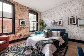 Relax in the living area with a smart TV, stylish seating, and a queen-sized sleeper sofa for extra guests. Perfect for families or group stays in New Orleans, this inviting space is ideal for movie nights or recharging after a day in the city.