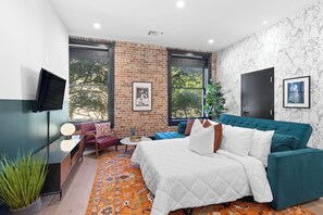 Relax in the living area with a smart TV, stylish seating, and a queen-sized sleeper sofa for extra guests. Perfect for families or group stays in New Orleans, this inviting space is ideal for movie nights or recharging after a day in the city.