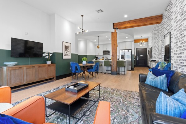 Relax in the living area with a smart TV, stylish seating, and a sleeper sofa for extra guests. Perfect for families or group stays in New Orleans, this inviting space is ideal for movie nights or recharging after a day in the city.