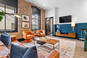Relax in the living area with a smart TV, stylish seating, and a sleeper sofa for extra guests. Perfect for families or group stays in New Orleans, this inviting space is ideal for movie nights or recharging after a day in the city.