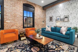 Relax in the living area with a smart TV, stylish seating, and a sleeper sofa for extra guests. Perfect for families or group stays in New Orleans, this inviting space is ideal for movie nights or recharging after a day in the city.