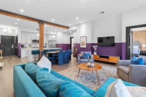 Relax in the living area with a smart TV, stylish seating, and a sleeper sofa for extra guests. Perfect for families or group stays in New Orleans, this inviting space is ideal for movie nights or recharging after a day in the city.