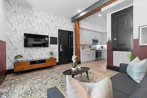 Relax in the living area with a smart TV, stylish seating, and a sleeper sofa for extra guests. Perfect for families or group stays in New Orleans, this inviting space is ideal for movie nights or recharging after a day in the city.
